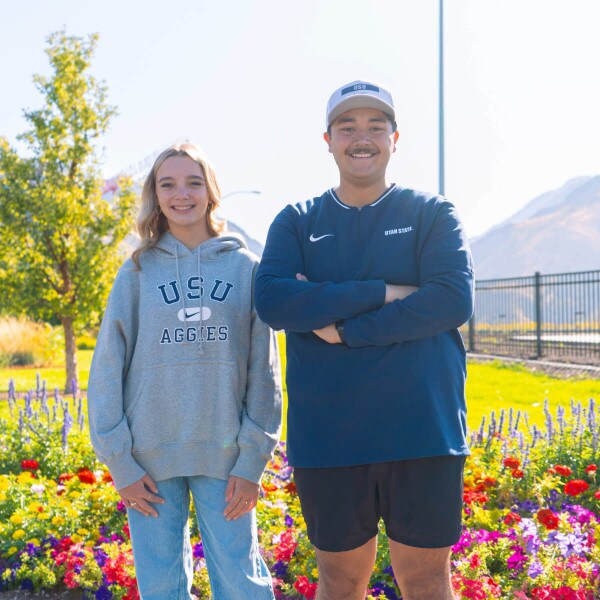 Aggies wearing Nike Gear in Front of Flowers